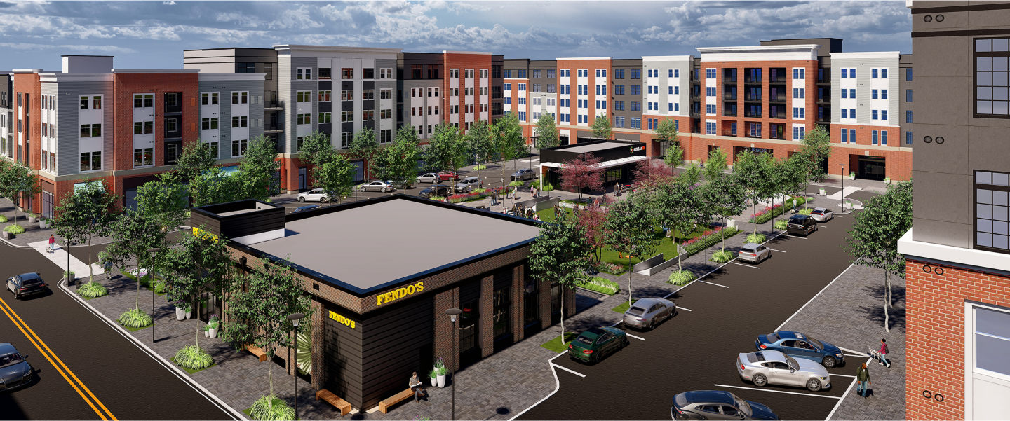 Multi-building aerial rendering of The Core Station Yards surrounding a tree-lined town center bordered by streets