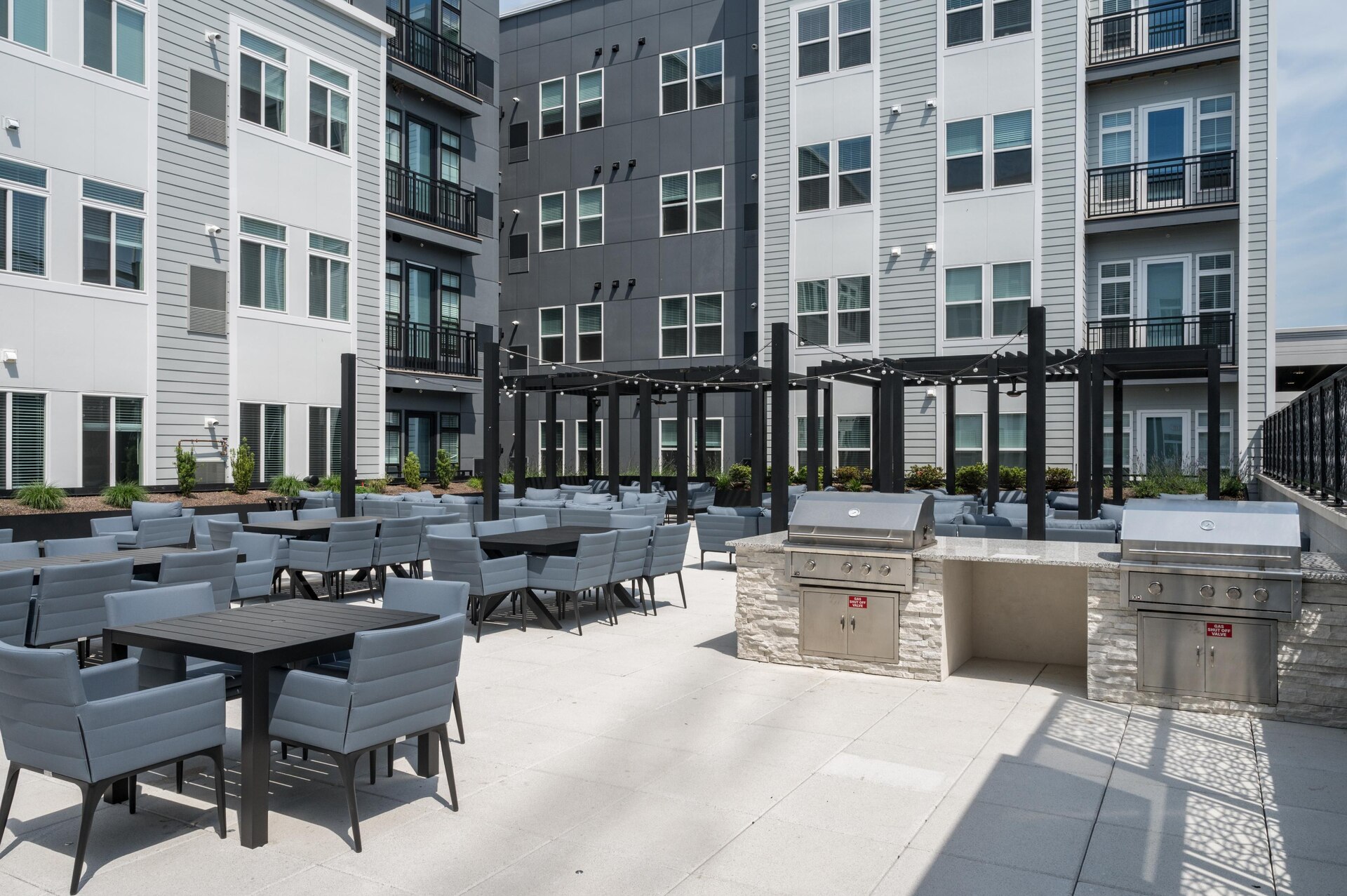 Outdoor seating area with grills.