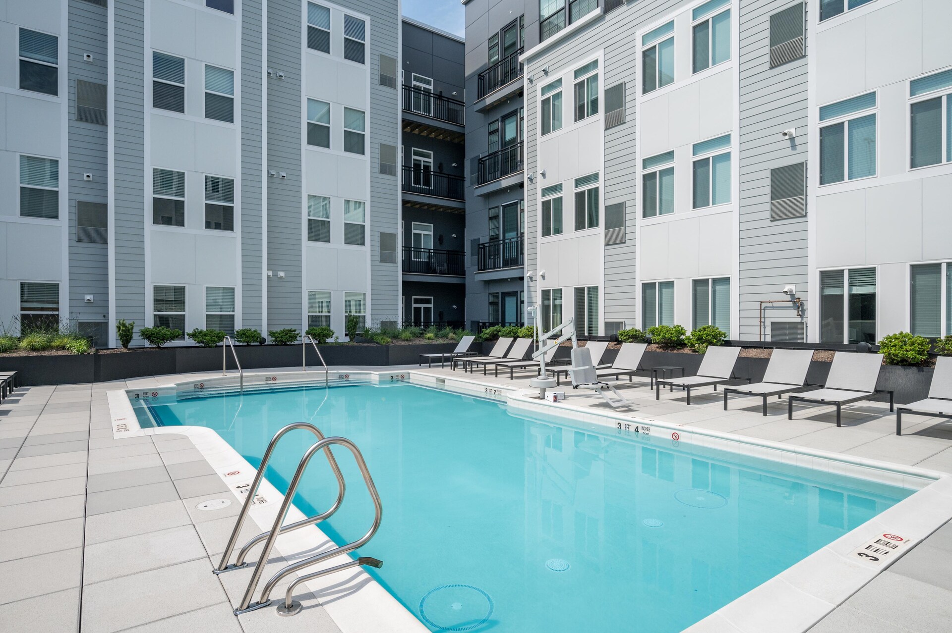 Swimming pool with poolside seating.